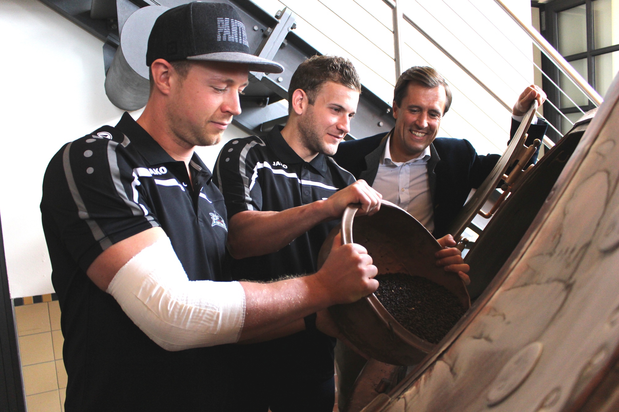 Die AEV-Spieler geben das Malz in den Maischbottich. Foto: Isabell Walter/B4B WIRTSCHAFTSLEBEN SCHWABEN