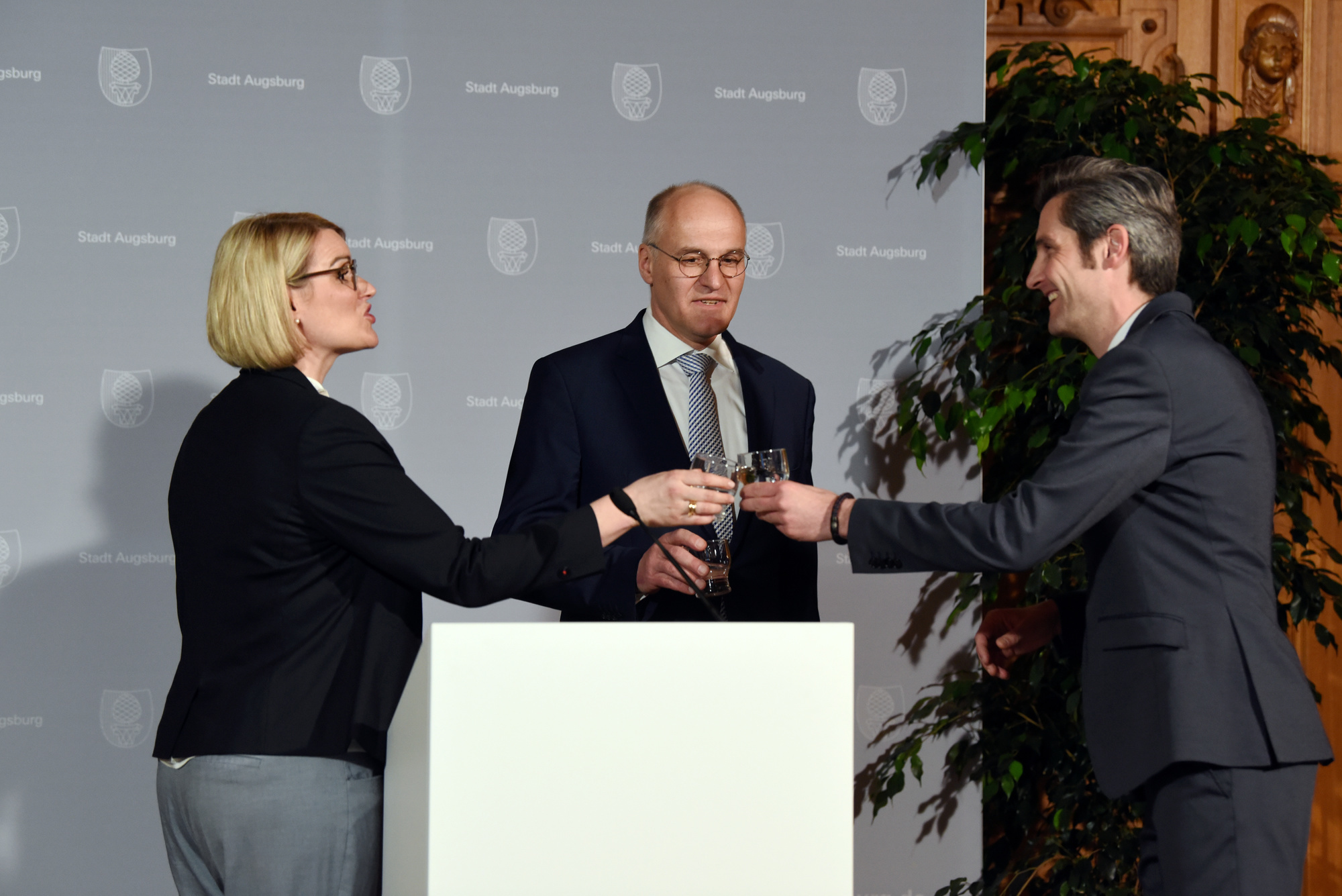 Bei der Pressekonferenz, die wegen des Coronavirus als Live-Stream ohne anwesendes Publikum übertragen wurde, wurde mit OB Dr.Kurt Gribl und SPD-Kandidat Ordnungsreferent Dirk Wurm improvisiert und mit einem „Schluck Wasser“ angestoßen. Foto: Ruth Pössel