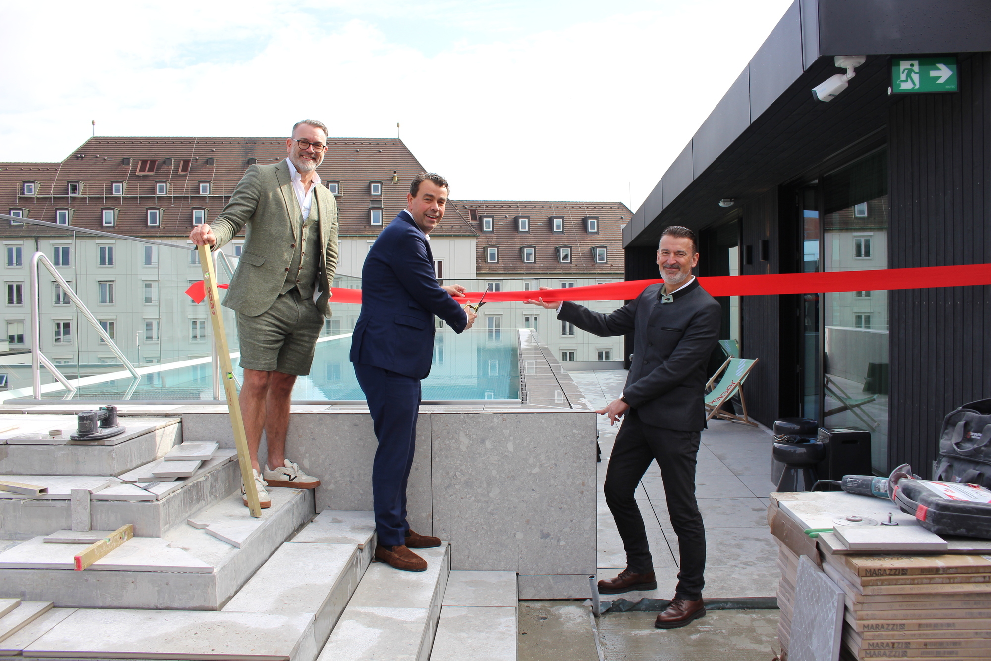 Die symbolische Schlüsselübergabe für den Neubau. Von links: Architekt Christian Fußner, Theodor Gandenheimer, Managing Director des Hotel Maximilian's, und Michael Stöckel, Niederlassungsleiter Geiger Schlüsselfertigbau in Augsburg.